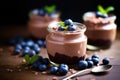 Chocolate mousse with blueberries and mint in a glass jar, Chocolate mousse garnished with fresh blueberries served in glass jars