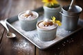 chocolate mousse in rustic metal cups, powdered sugar dusted