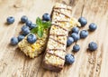 Chocolate Muesli Bar with Blueberries on Wooden Background Royalty Free Stock Photo