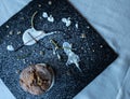 Chocolate muffin on a black board indicated by yogurt, lemon zest and icing sugar