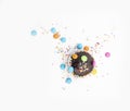 Chocolate muffin in brown paper with colorful chocolate pieces isolated on white background, top view Royalty Free Stock Photo