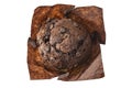 Chocolate muffin in brown paper isolated on white background, top view Royalty Free Stock Photo