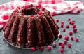 Chocolate muffin with cherry, cranberry and lecker on a white wooden background. Close-up. Royalty Free Stock Photo