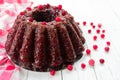 Chocolate muffin with cherry, cranberry and lecker on a white wooden background. Close-up. Royalty Free Stock Photo