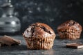 Chocolate muffin on dark background, closeup. Homemade delicious chocolate muffins on black board