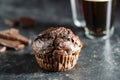 Chocolate muffin on dark background, closeup. Homemade delicious chocolate muffins on black board