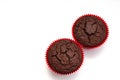 Chocolate muffin in red tartlet. two. view from above. isolated on white background. Royalty Free Stock Photo