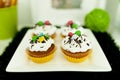 Cupcakes with colored on a white plate Royalty Free Stock Photo