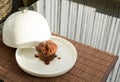 Chocolate muffin under the ceramic salver over white dish Royalty Free Stock Photo