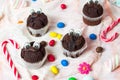 Chocolate muffins with edible eyes and colorful bonbons Royalty Free Stock Photo