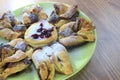 Chocolate nugget puff pastry flower with the vanilla sauce and sour cherry covered with powdered sugar