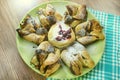 Chocolate nugget puff pastry flower with the vanilla sauce and sour cherry covered with powdered sugar, green and brown