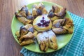 Chocolate nugget puff pastry flower with the vanilla sauce and sour cherry covered with powdered sugar, green and brown