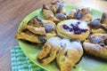 Chocolate nugget puff pastry flower with the vanilla sauce and sour cherry covered with powdered sugar Royalty Free Stock Photo