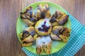 Chocolate nugget puff pastry flower with the vanilla sauce and sour cherry covered with powdered sugar, green and brown wooden bac