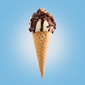 Chocolate nuts ice cream cone on blue background