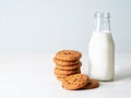 Chocolate oatmeal cookies and milk in bottle, healthy snack. Light background, grey light wall Royalty Free Stock Photo