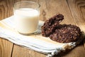 chocolate oatmeal coolies and glass of milk on woden table