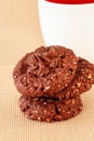 Chocolate oats cookies with chocolate nuts spread. Beige background. Selective focus