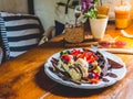 Chocolate Pancakes with banana, strawberry, blueberry, whipping cream and vanilla ice cream, icing sugar, brownies and chocolate s Royalty Free Stock Photo