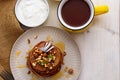 Chocolate pancakes with kiwi, hazelnut, honey on plate with sour cream and cup of cocoa on white background Royalty Free Stock Photo