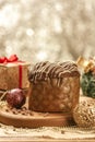 Chocolate panettone on wooden table with christmas ornaments