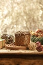 Chocolate panettone on wooden table with christmas ornaments