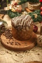 Chocolate panettone on wooden table with christmas ornaments