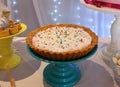 Chocolate pie with cream, sparkling dots, whipped cream and sugar colorful candy. Handmade candy