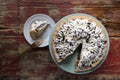 Chocolate pie with cut slice on rustic table
