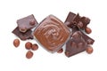 Chocolate pieces, bowl of sweet paste and hazelnuts on white background, top view Royalty Free Stock Photo