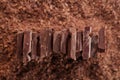 Chocolate pieces on grated chocolate background