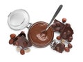 Chocolate pieces, jar with sweet paste and hazelnuts on white background, top view Royalty Free Stock Photo