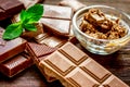 Chocolate pieces with mint on wooden table background Royalty Free Stock Photo