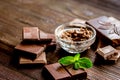 Chocolate pieces with mint on wooden table background Royalty Free Stock Photo