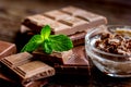 Chocolate pieces with mint on wooden table background Royalty Free Stock Photo