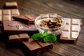 Chocolate pieces with mint on wooden table background Royalty Free Stock Photo