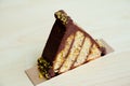 Chocolate Pistachio Triangle on wood background Royalty Free Stock Photo