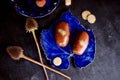 Chocolate potato cake with gold powder on the deep blue plate.A work of culinary art