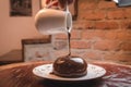 Chocolate pouring over cake