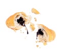 Chocolate pouring from two halves of a croissant close-up on white background Royalty Free Stock Photo