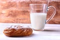 Chocolate and powdered sugar cream puff rings, choux pastry and glass with milk Royalty Free Stock Photo