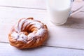 Chocolate and powdered sugar cream puff rings, choux pastry and glass with milk Royalty Free Stock Photo
