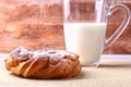 Chocolate and powdered sugar cream puff rings, choux pastry and glass with milk Royalty Free Stock Photo