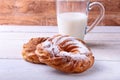 Chocolate and powdered sugar cream puff rings, choux pastry and glass with milk Royalty Free Stock Photo