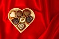 Chocolate pralines in golden heart shape box