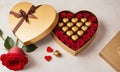 Chocolate pralines golden heart shape box Valentine\'s Day gift, with red rose decoration Royalty Free Stock Photo