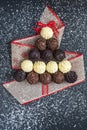 Chocolate pralines shape Christmas tree on black Royalty Free Stock Photo