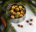 Chocolate pralines wrapped in gold foil with Christmas tree sprig Royalty Free Stock Photo