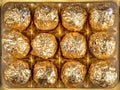 Chocolate pralines wrapped in gold foil Royalty Free Stock Photo